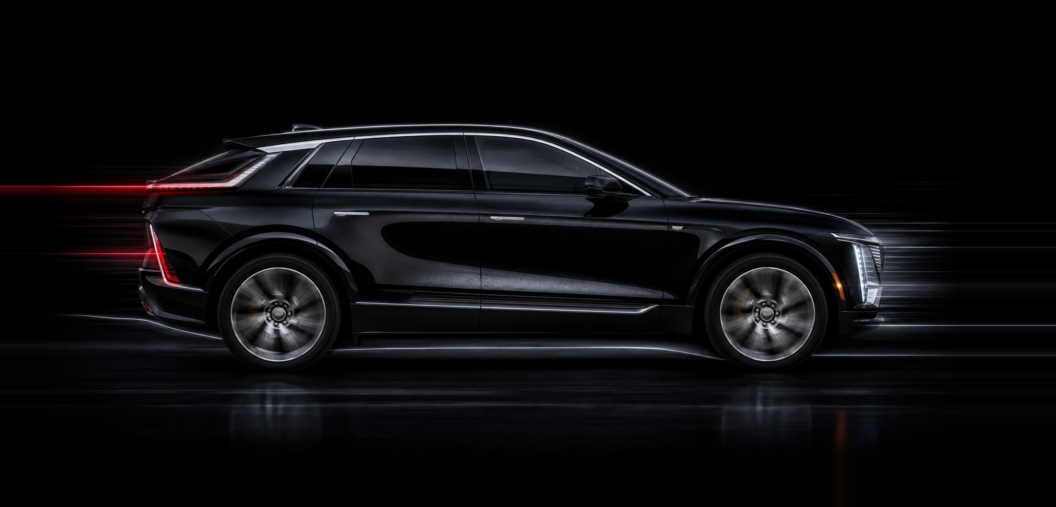 A black Cadillac Lyriq in profile under studio light, the full length of the body a calibration has to be measured against