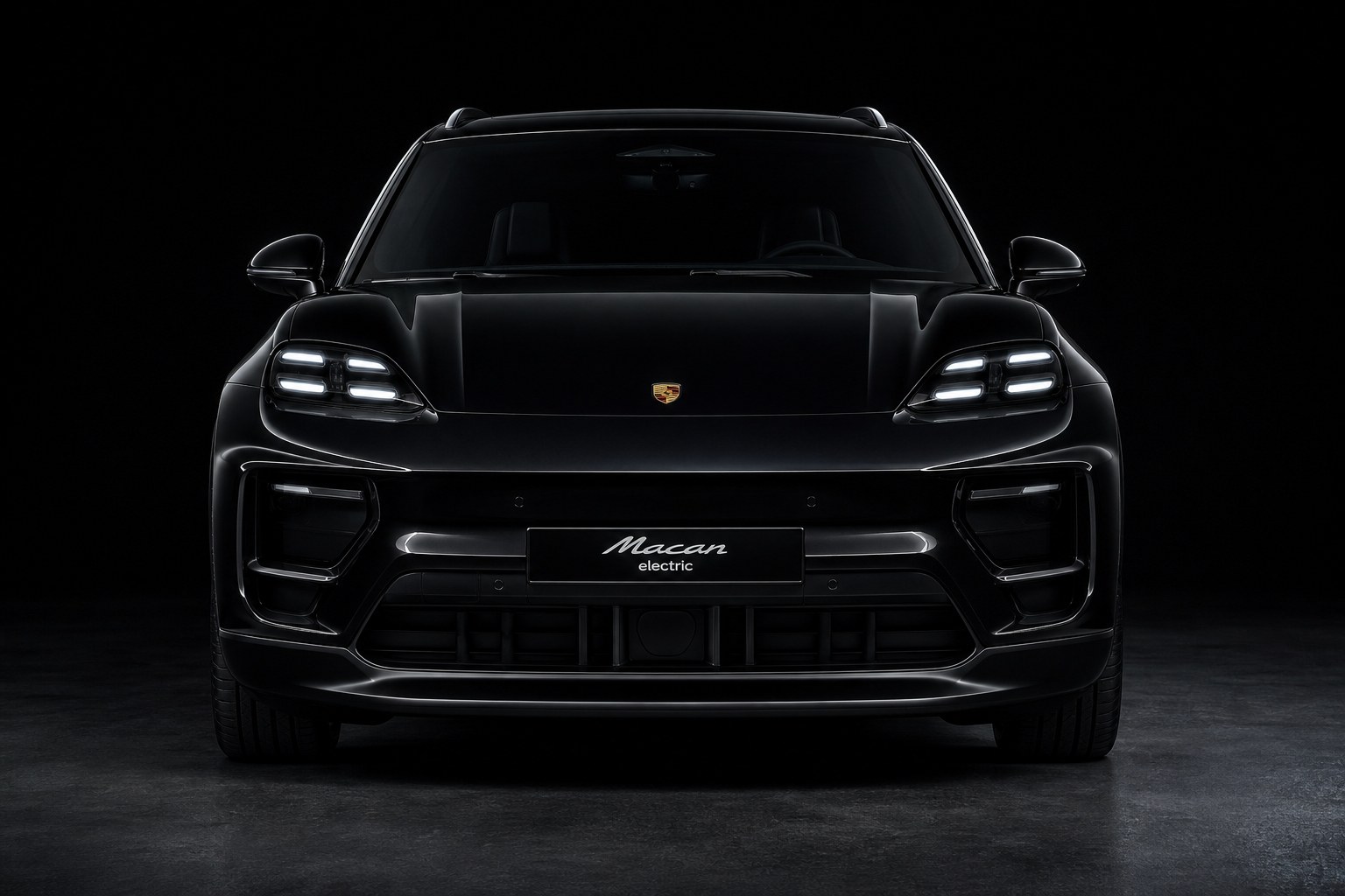 A black Porsche Macan Electric head-on against a dark studio backdrop: front lid, both headlights, bumper and lower intakes, the panels a collision repair replaces